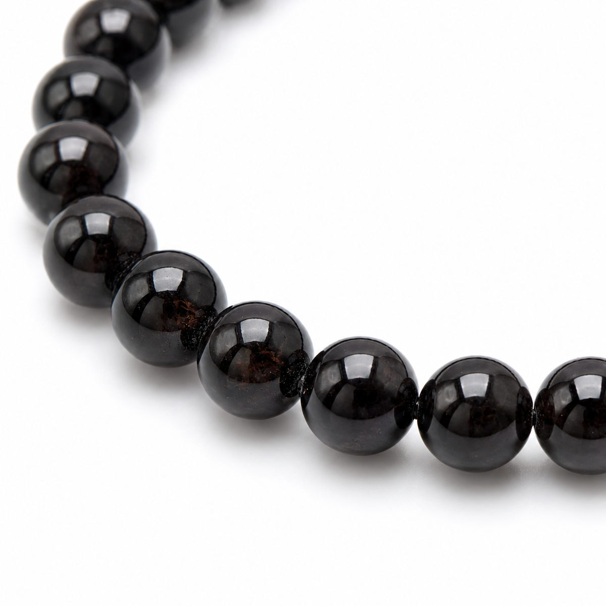 Close-up of the deep red garnet beads and elastic threading