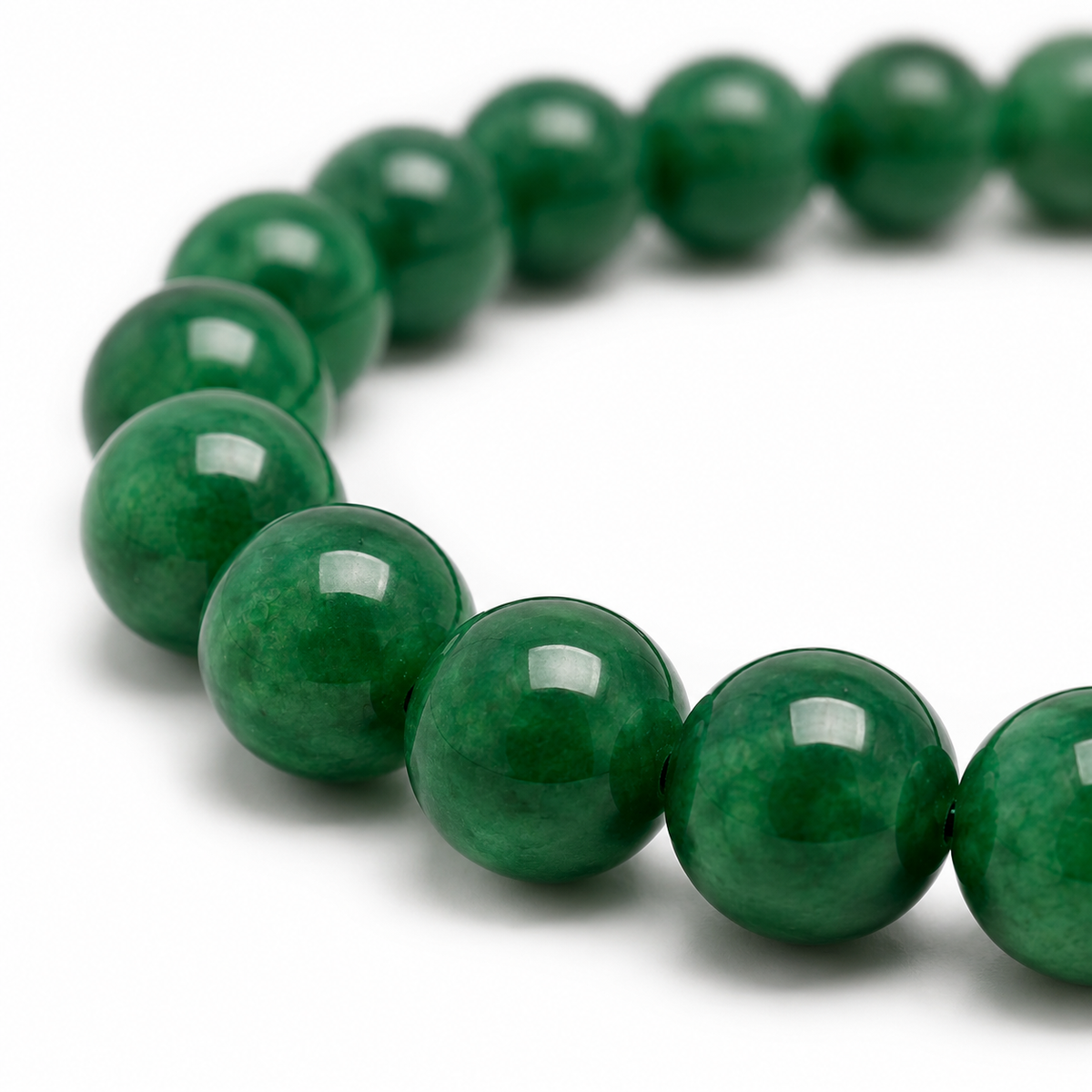 Close-up of the polished green jade beads and elastic threading