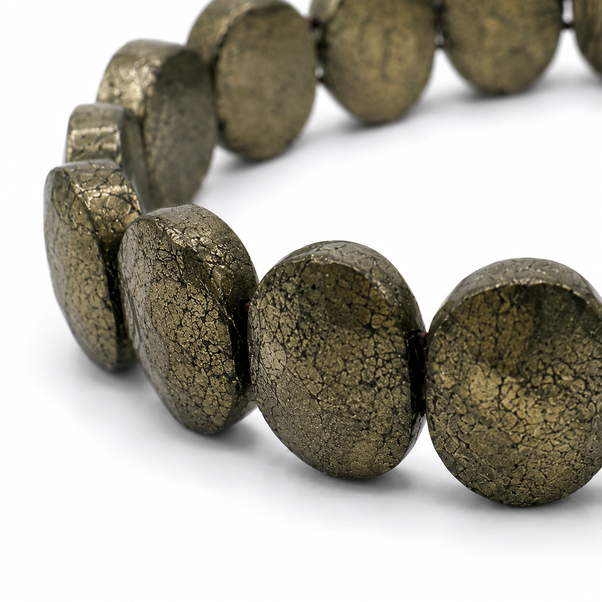 Close-up of the faceted oval-cut pyrite beads and elastic threading