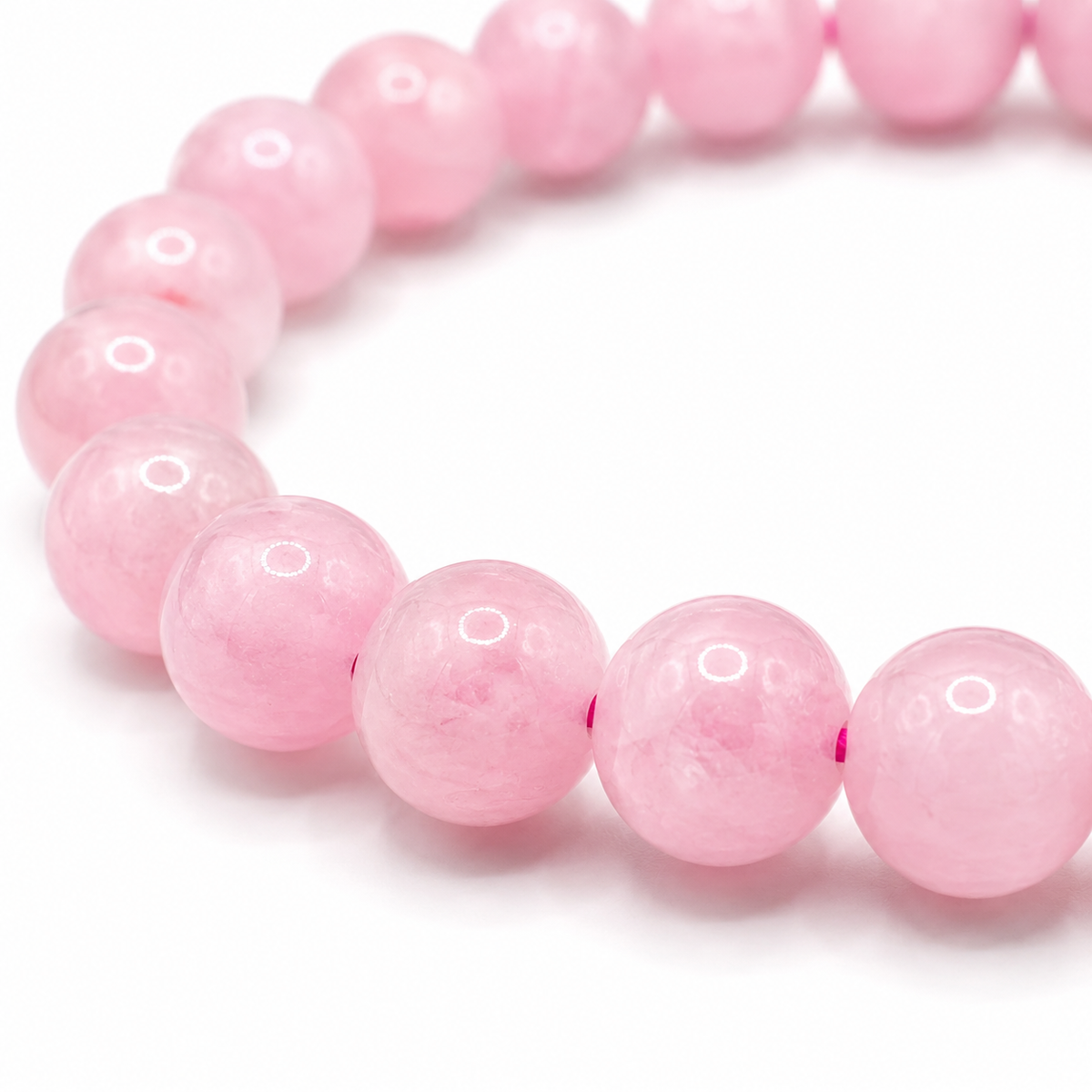 Close-up of the soft pink rose quartz beads and elastic threading